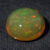 Natural Brazilian opal gemstone on dark textured fabric