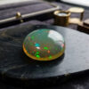 Natural Brazilian opal gemstone on black stone jewelry display