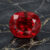 Natural cushion cut Burma red spinel gemstone on black marble surface