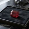 Natural emerald cut Burma ruby with GIA report on black jewelry display
