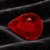 Natural pear shaped Burma ruby gemstone on black velvet fabric