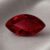 Natural marquise cut Burma ruby gemstone on soft grey fabric
