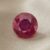 Natural round Burma ruby with GIA report on soft beige fabric