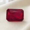 Natural emerald cut Burma ruby with GIA report on soft cream fabric