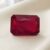 Natural emerald cut Burma ruby with GIA report on soft cream fabric