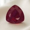 Natural pear shaped Burma ruby with GIA report on soft cream fabric