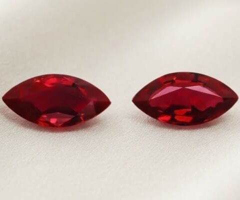 Natural marquise cut Burma ruby matching pair on soft cream fabric