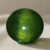 Natural cat’s eye demantoid garnet with GIA report on soft beige fabric