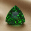 Natural trillion cut chrome tourmaline gemstone on soft beige fabric