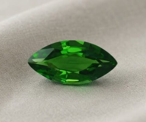 Natural marquise cut chrome tourmaline gemstone on soft beige fabric