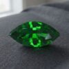 Natural marquise cut chrome tourmaline gemstone on dark grey fabric