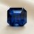 Natural octagonal cobalt spinel gemstone on soft cream fabric