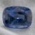 Natural cushion cut cobalt spinel gemstone on soft grey fabric