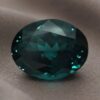 Natural oval color change garnet with GIA report on soft grey fabric