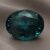 Natural oval color change garnet with GIA report on soft grey fabric