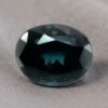 Natural oval color change garnet gemstone on soft grey fabric