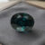 Natural color change garnet with GIA report on soft grey jewelry display