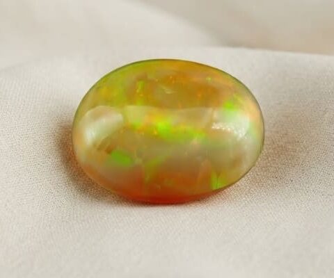 Natural Ethiopian opal with GIA report on soft cream fabric