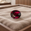 Natural Mozambique purple garnet matching pair on soft beige jewelry display