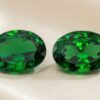 Natural oval tsavorite matching pair on soft cream fabric