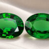 Natural oval tsavorite matching pair on soft cream fabric
