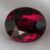 Natural oval garnet gemstone on soft grey fabric