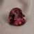 Natural heart shaped garnet gemstone on soft beige fabric