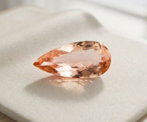 Natural imperial topaz gemstone, pear cut angled view