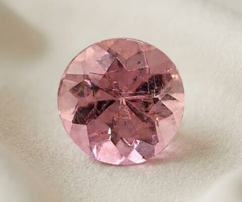 Natural imperial topaz gemstone, round cut front view
