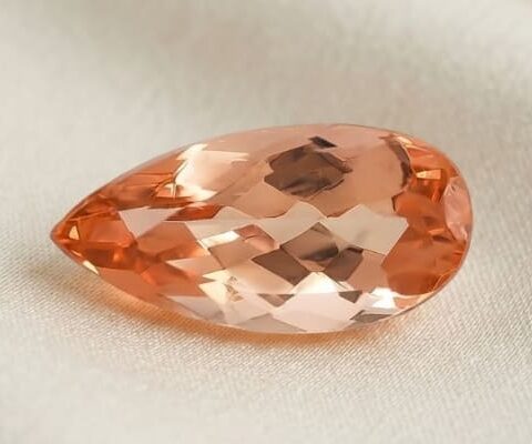 Natural imperial topaz gemstone, pear cut front view