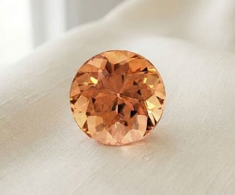 Natural imperial topaz gemstone, round cut front view