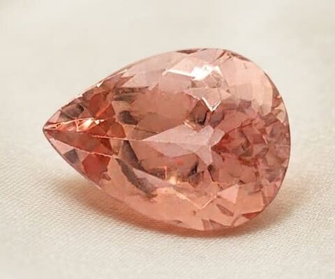 Natural imperial topaz gemstone, pear cut front view