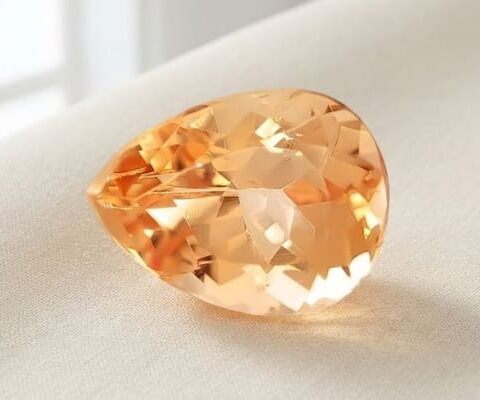 Natural imperial topaz gemstone, pear cut front view