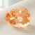 Natural imperial topaz gemstone, pear cut front view