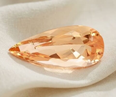Natural imperial topaz gemstone, pear cut front view