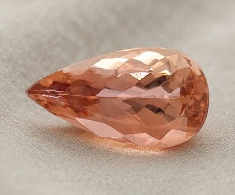 Natural imperial topaz gemstone, pear cut front view