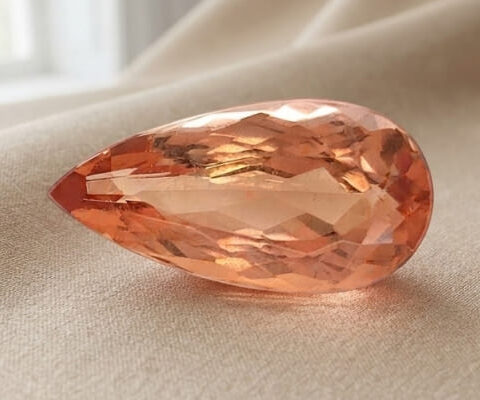 Natural imperial topaz gemstone, pear cut front view