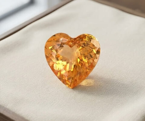 Front view of heart-shaped natural imperial topaz gemstone