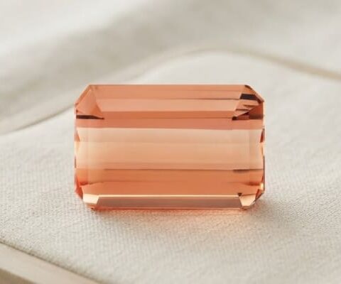 Front view of emerald-cut natural imperial topaz gemstone