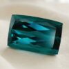 Natural Indicolite Blue Tourmaline cushion cut gemstone on ivory fabric