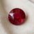 Natural Mozambique Ruby round cut red gemstone on ivory fabric