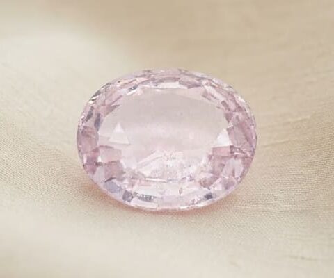 Natural oval peach sapphire gemstone top viewNatural oval peach sapphire gemstone top view