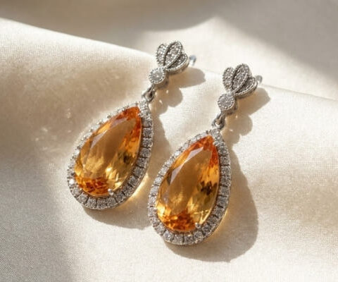Pear Yellow Topaz and Diamond Drop Earrings on Satin Background