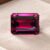 Natural Rhodolite Garnet gemstone with deep pinkish-red color and emerald cut, front view.