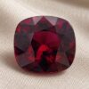 Natural Rhodolite Garnet gemstone with deep red color and cushion cut, front view.