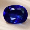 Natural Royal Blue Sapphire gemstone with vivid blue color and oval cut, front view.