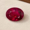 Natural Rubellite Tourmaline gemstone with rich raspberry-red color and oval cut, front view.