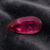 Natural Rubellite Tourmaline gemstone with vibrant raspberry-pink color and pear cut, angled view.