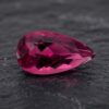 Natural Rubellite Tourmaline gemstone with vibrant raspberry-pink color and pear cut, front view.